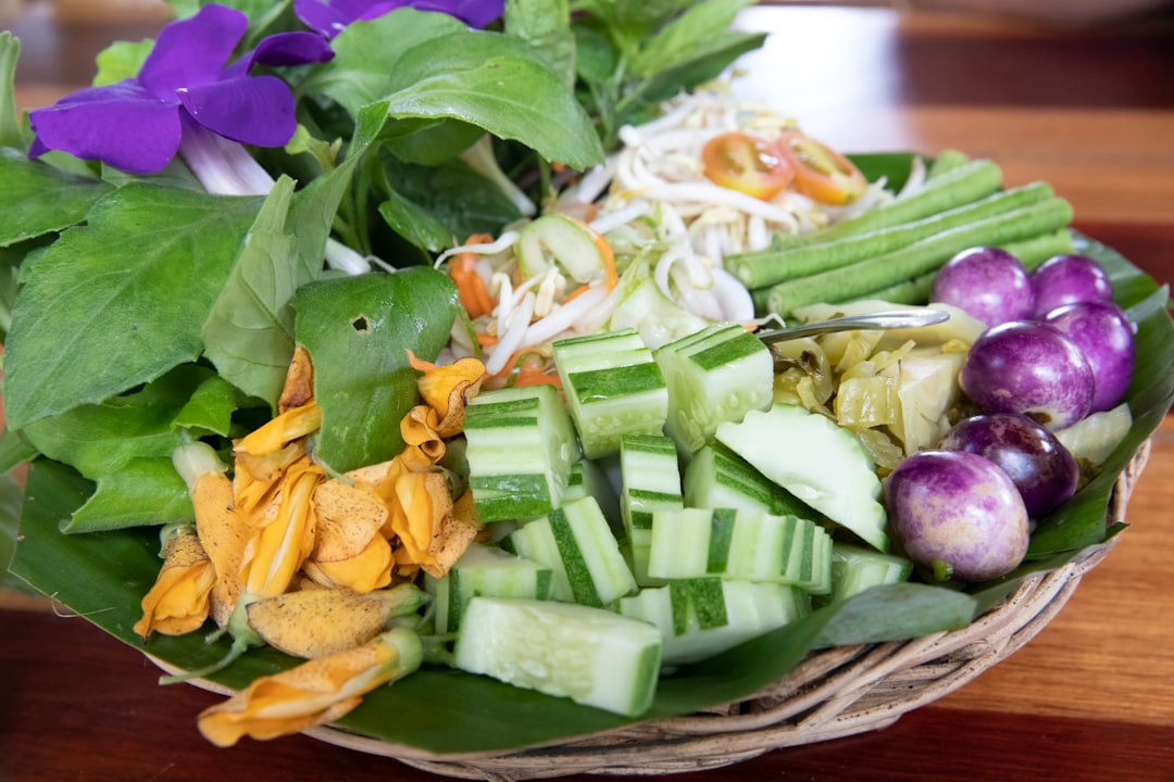 Vegetable salad with flower - thailand - ranong by Keto Paleo Recipes vegetable salad on brown wooden plate